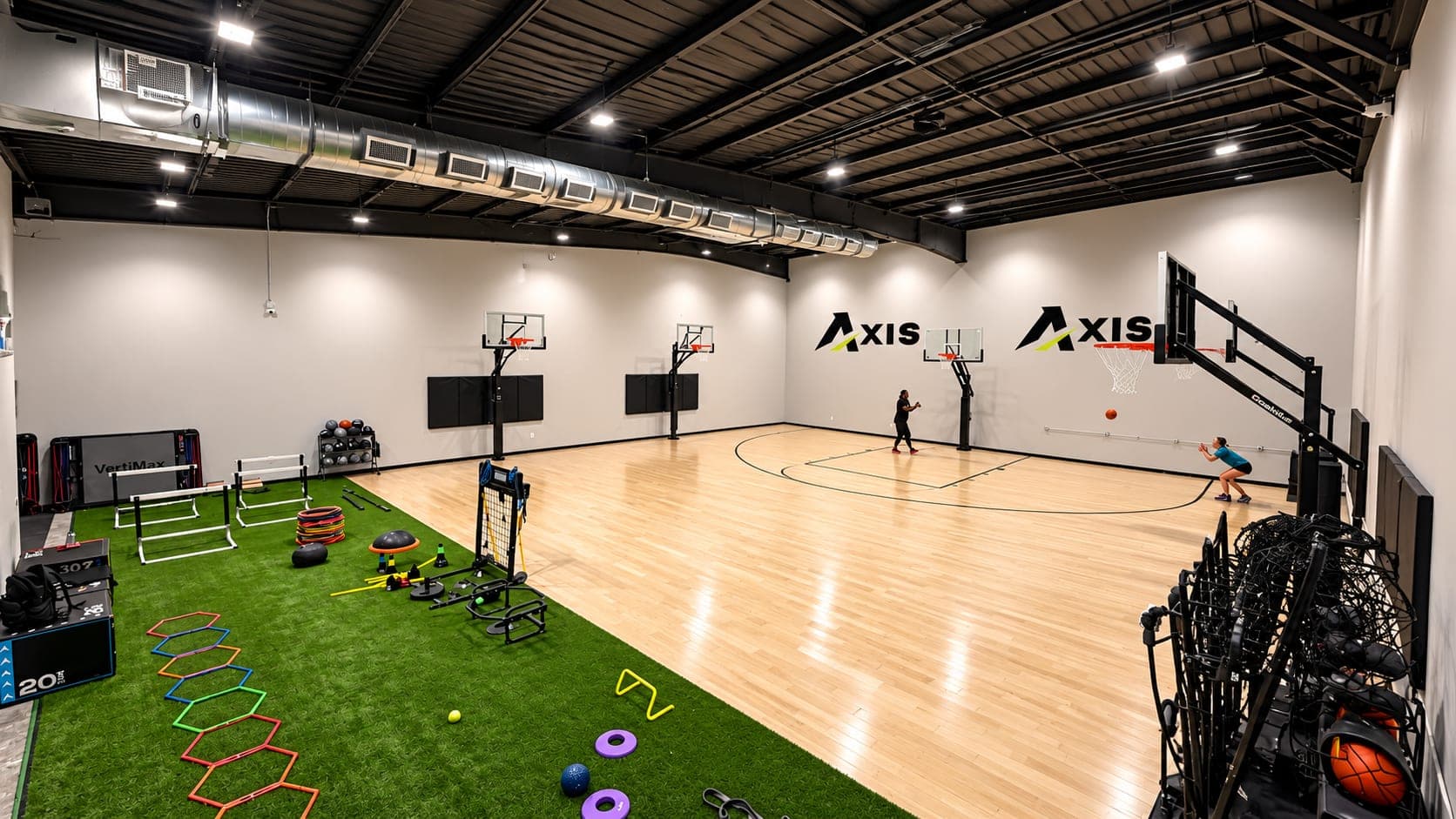 The indoor basketball court and turf lane at Axis Sports Lab in Katy, where sscdReps Training Pods run